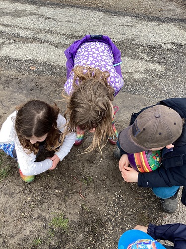Children searching for worms outside
