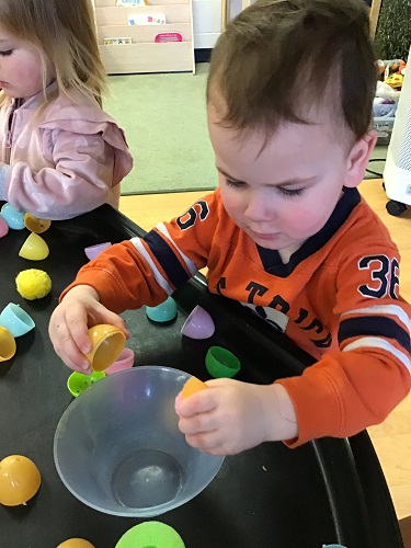 Toddler cracking egg open