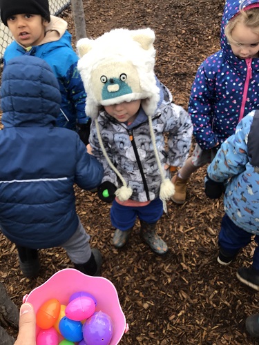 Children putting eggs into the basket