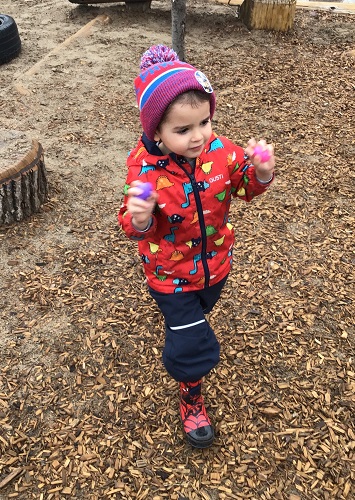 A child showing off the two eggs he found on the playground