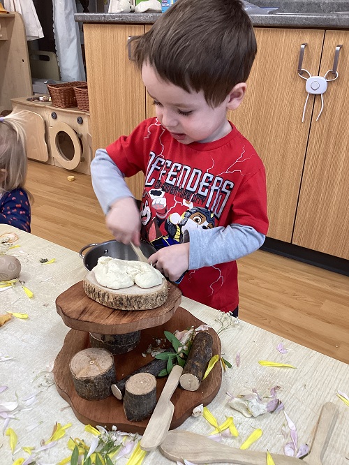 A toddler child exploring with natural materials