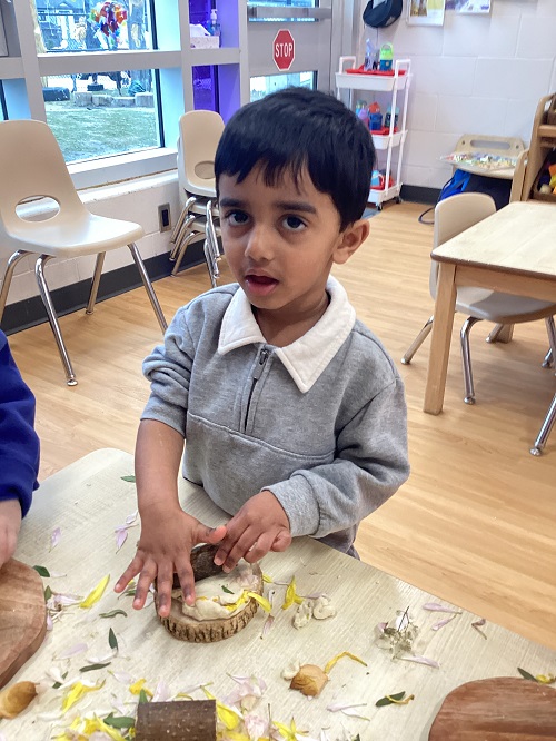 A toddler child exploring with natural materials