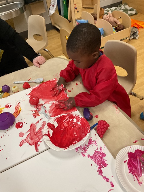 child with red paint