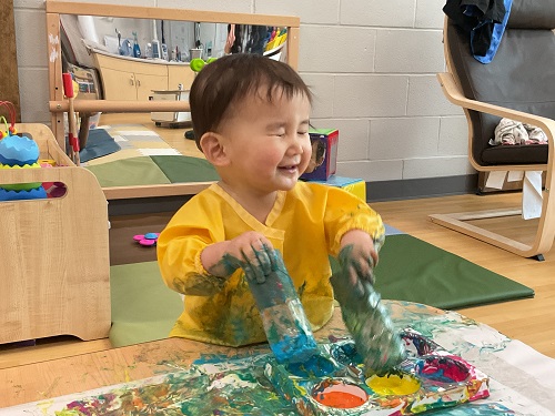 baby in yellow painting 2 tubes