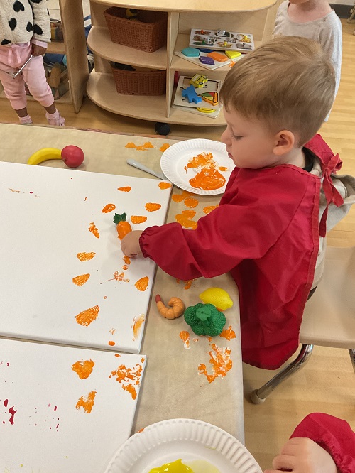 child painting with carrots