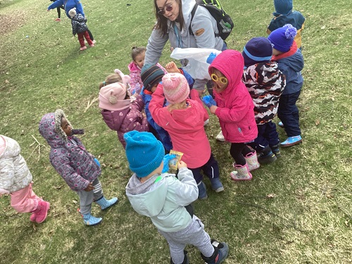 group of children picking up garbage outside