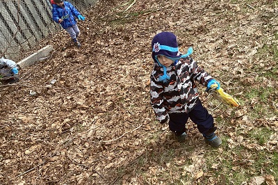 child picking up litter