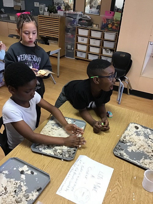 Children creating craters during sensory play