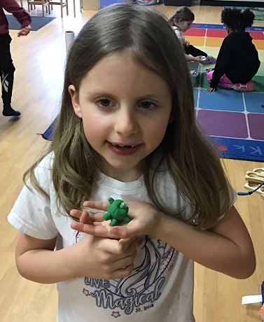 child showing their creation