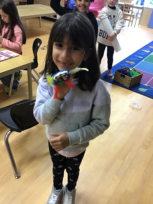 child showing their creation