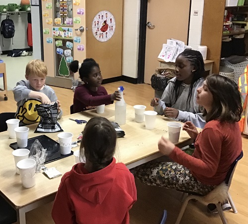 5 children sitting around a table