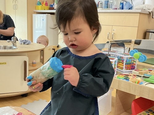 Infants exploring texture through bubble wrap and paint