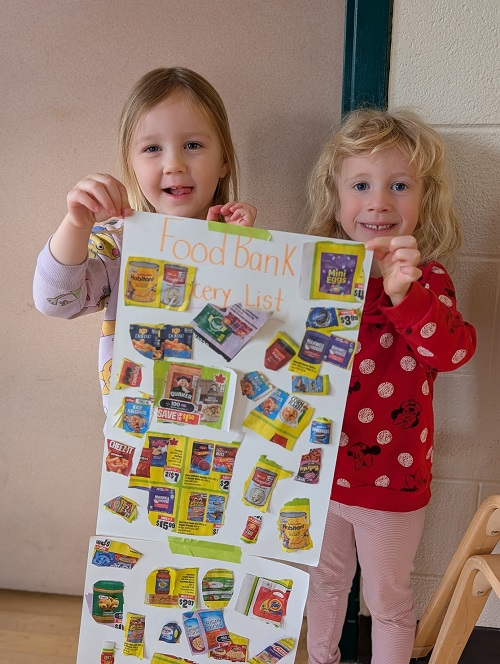 children holding up their shopping list