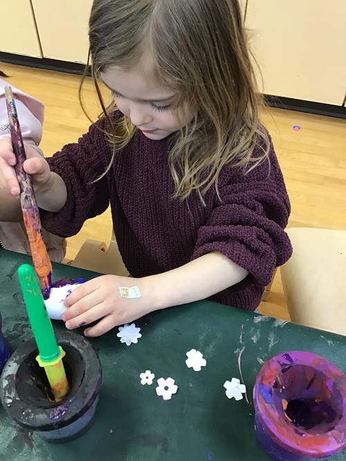 Child painting egg.